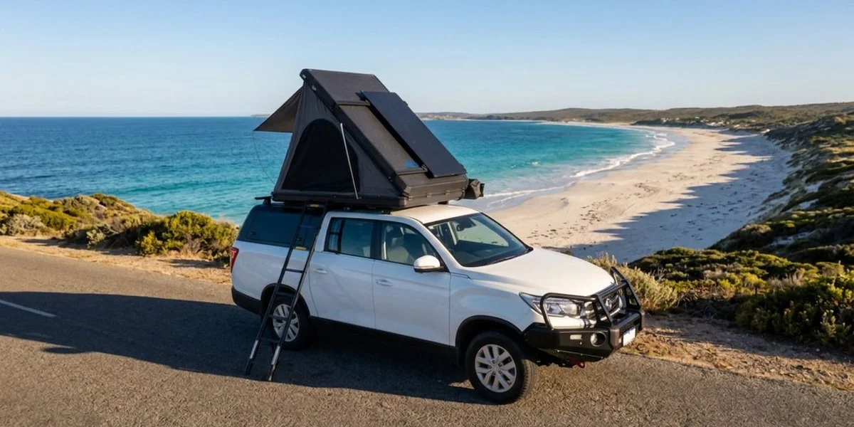 Scenic coastal road winding along turquoise waters and white sand beaches in the South West of Western Australia during golden hour